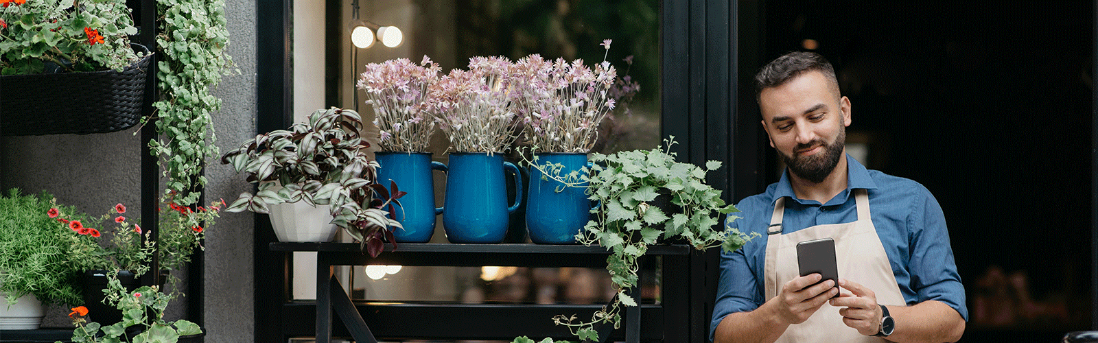 Florist looking at their account on their phone. 