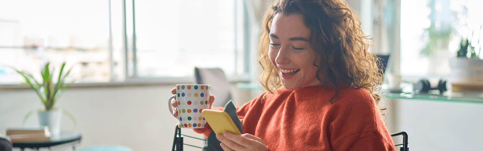 A member looking at her account on her phone. 