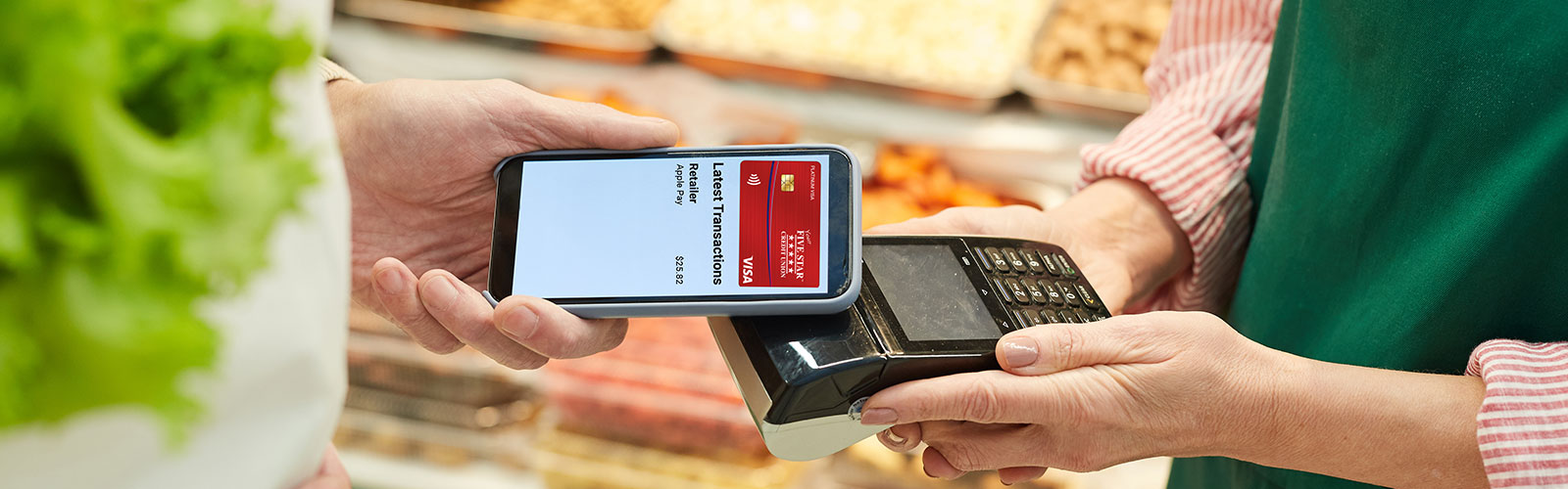 Someone making a contactless purchase with the Five Star Platinum Visa card.