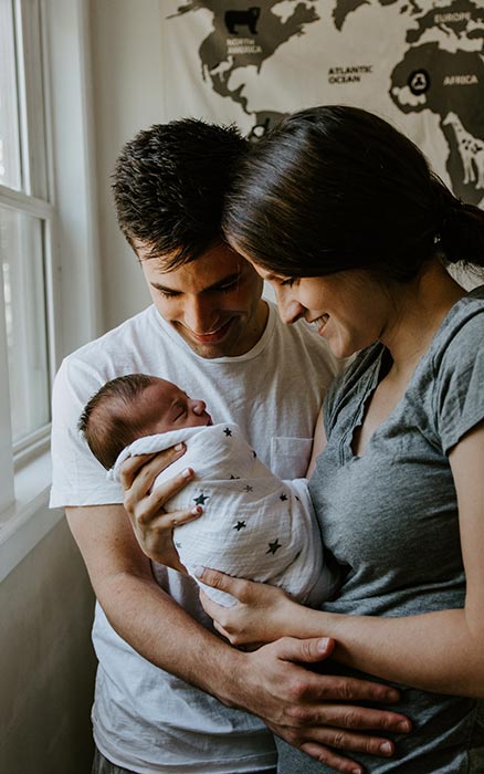 A young couple with a newborn baby